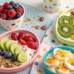 Assortment of quick and healthy toddler breakfast options including fruit, yogurt, toast, and eggs on a kitchen counter