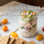 Canned chicken salad served in a mason jar with fresh veggies and crackers